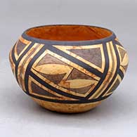 A mixed clay bowl decorated around the outside with a four panel black fineline and geometric design
 by Calvin Analla Jr of Laguna