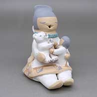 Polychrome storyteller with a child and a polar bear cub
 by Stella Teller of Isleta