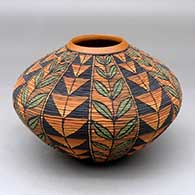 A polychrome tiny coil jar decorated with a twelve panel plant and geometric design
 by Richard Zane Smith of Wyandot