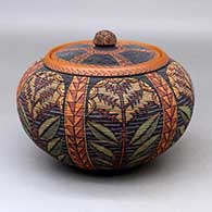 A lidded polychrome tiny coil jar decorated with a six panel plant and geometric design
 by Richard Zane Smith of Wyandot
