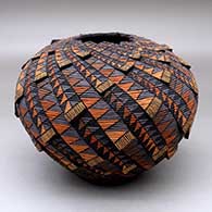 A polychrome tiny coil jar with a notched rim and decorated with appliques and a geometric design
 by Richard Zane Smith of Wyandot