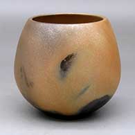 A golden micaceous jar with fire clouds
 by Robert Vigil of Nambe