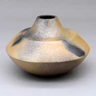 A golden micaceous jar with fire clouds
 by Robert Vigil of Nambe