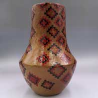 Polychrome tall neck jar with a sgraffito and painted Dineh carpet design, click or tap to see a larger version