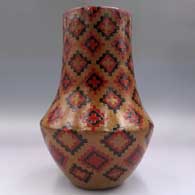 Polychrome tall neck jar with a sgraffito and painted Dineh carpet design, click or tap to see a larger version