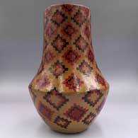 Polychrome tall neck jar with a sgraffito and painted Dineh carpet design, click or tap to see a larger version