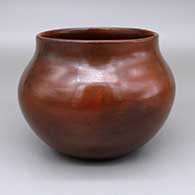 Red jar with a pine pitch coating and fire clouds
 by Susie Crank of Dineh