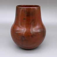 Red jar with a pine pitch coating and fire clouds
 by Susie Crank of Dineh