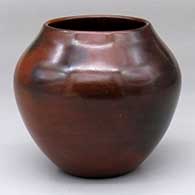 A polished brown jar decorated with fire clouds
 by Susie Crank of Dineh