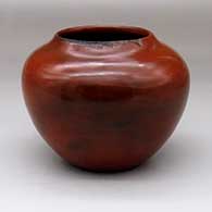 A brown jar with fire clouds and a sgraffito geometric design on the rim
 by Sue Williams of Dineh