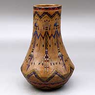 Click for a larger view A polychrome tall-neck jar decorated with a yeibichai and geometric Navajo carpet design
by Nancy Yazzie of Dineh