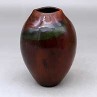 A polished brown vase with a square opening and decorated with fire clouds
 by Alice Cling of Dineh