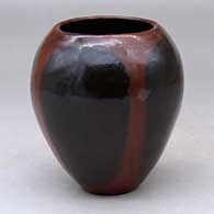 A polished brown jar decorated with fire clouds
 by Alice Cling of Dineh