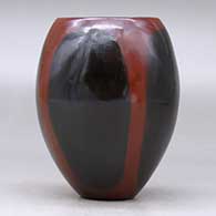 A polished brown jar decorated with fire clouds, click or tap to see a larger version