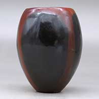 A polished brown jar decorated with fire clouds, click or tap to see a larger version