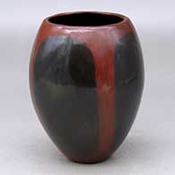 A polished brown jar decorated with fire clouds
 by Alice Cling of Dineh