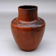 A polished brown jar with fire clouds decorated above the shoulder with a sgraffito geometric design
 by Sue Williams of Dineh