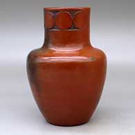 A polished brown jar with fire clouds decorated around the neck with a sgraffito geometric design, click or tap to see a larger version