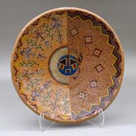 A wide polychrome bowl decorated inside with a sgraffito and painted Yeibichai, sun, feather, star and geometric design, and decorated outside with bands of Navajo carpet design
 by Nancy Yazzie of Dineh