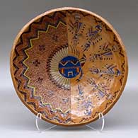 An open polychrome bowl decorated inside with a sgraffito and painted Yeibichai, sun, feather, star and geometric design, and decorated outside with bands of Navajo carpet design
 by Nancy Yazzie of Dineh