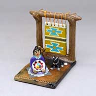 A Dineh woman and her loom with a welcome basket, a dog and a wedding vase
 by Elizabeth Manygoats of Dineh