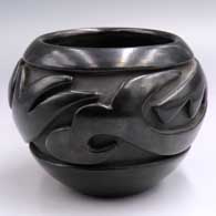 Black jar carved around the shoulder with a stylized avanyu design
 by Teresita Naranjo of Santa Clara