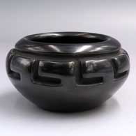 Black jar carved with a geometric design around the shoulder
 by Mary Ester Archuleta of Santa Clara