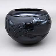 Black bowl with a carved avanyu design
 by Joy Cain of Santa Clara