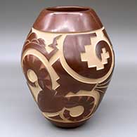 A sepia jar carved with a bighorn ram, cloud formation, rain drop, kiva step and geometric design
 by Ryan Roller of Santa Clara
