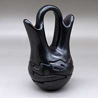 A black wedding vase with an avanyu designed carved around the body
 by Vickie Martinez of Santa Clara
