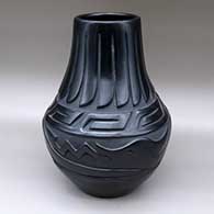 A black jar carved around the body with an avanyu design, above the neck with a scrolls design and around the neck itself with a band-of-feathers design
 by Mary Singer of Santa Clara