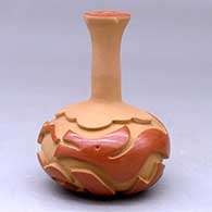 A buff and red long stem vase decorated with a carved avanyu and geometric design around the body
 by Linda Cain of Santa Clara