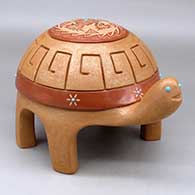 A red and golden micaceous turtle figure decorated with a geometrically carved shell and a sgraffito hummingbird, flower and geometric design, plus multiple inlaid stones
 by Melony Gutierrez of Santa Clara