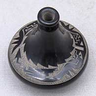 A black miniature tall neck jar decorated with a sgraffito avanyu and geometric design between the shoulder and the neck
 by Geri Naranjo of Santa Clara