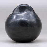 A small black jar with a geometric cut opening, click or tap to see a larger version