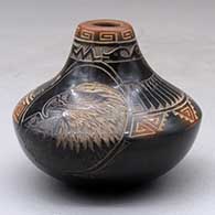 A small low shouldered black jar with a sienna rim and spots, decorated with a sgraffito eagle, feather, bear par and geometric design
 by Kevin Naranjo of Santa Clara