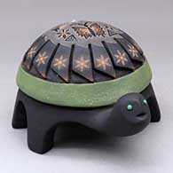 Click for a larger view A polychrome turtle figure carved with a feather design and decorated on top with a sgraffito hummingbird, butterfly, flower and geometric design plus inlaid stones
by Melony Gutierrez of Santa Clara