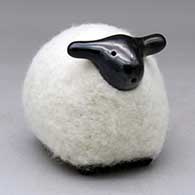 A black sheep figure clothed in a bundle of wool
 by Joe Naranjo of Santa Clara