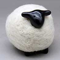 A black sheep figure clothed in a bundle of wool
 by Joe Naranjo of Santa Clara