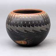 A black bowl with a sienna rim and spots decorated around the outside with a sgraffito knife edge, bear paw and geometric design
 by Sammy Naranjo of Santa Clara
