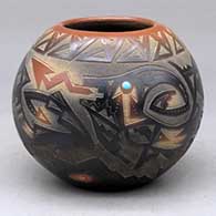 A black bowl with a sienna rim and spots decorated around with a sgraffito avanyu, bear paw and geometric design, plus an inlaid stone
 by Sammy Naranjo of Santa Clara