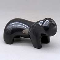 A standing black bear figure with a sgraffito bear paw design on its sides
 by Jarren Naranjo of Santa Clara