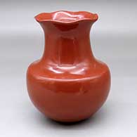 A polished red water jar with a pie crust rim
 by Tina Garcia of Santa Clara