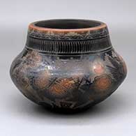 A black jar with a sienna rim and spots, decorated with a sgraffito butterfly, rose, flower, feather, avanyu and geometric design
 by Kevin Naranjo of Santa Clara