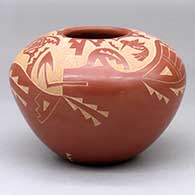 A red jar decorated with a sgraffito avanyu, hummingbird, butterfly and geometric design
 by Candelaria Suazo of Santa Clara