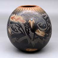 A black jar with a sienna rim and spots, decorated with a sgraffito avanyu, feather, bear paw and geometric design with an inlaid stone
 by Sammy Naranjo of Santa Clara