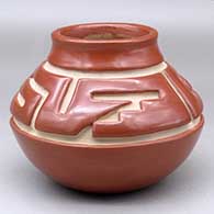 A red jar decorated with a two panel geometric design carved above the shoulder
 by Margaret Tafoya of Santa Clara