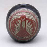 A miniature black seed pot with a sienna spot and a sgraffito thunderbird and geometric design
 by Joseph Lonewolf of Santa Clara