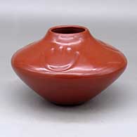 A red jar decorated with three bear paw imprints above the shoulder
 by Tina Garcia of Santa Clara