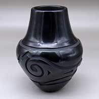 A black jar carved with an avanyu design
 by Sherry Tafoya of Santa Clara